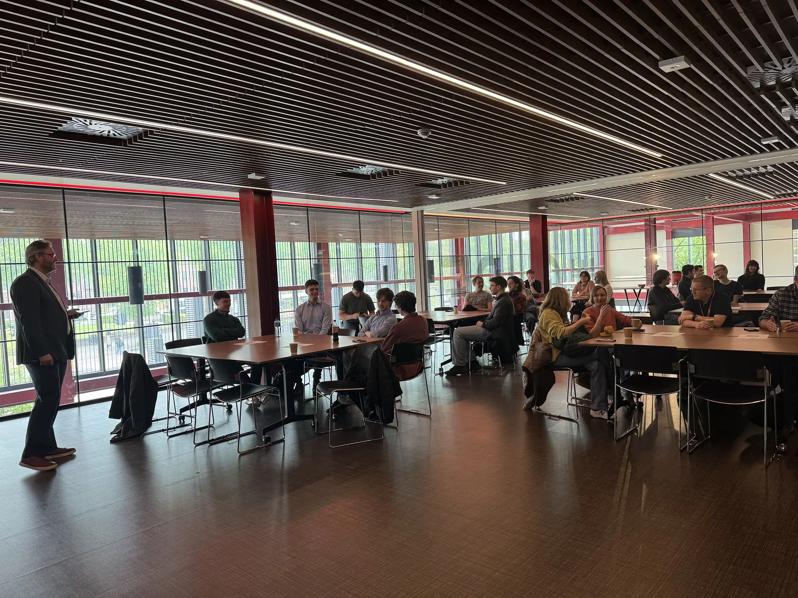 Wide view of the room as the first FASE NI event opens, speaker on the left and attendees seated around the room