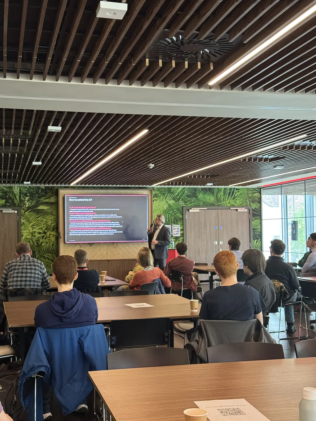View from the back of the room of the audience watching the speaker at the first FASE NI event